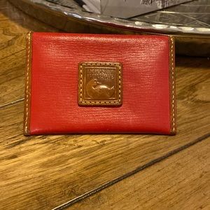 Dooney & Bourke red and brown leather card holder. Well loved in good condition.